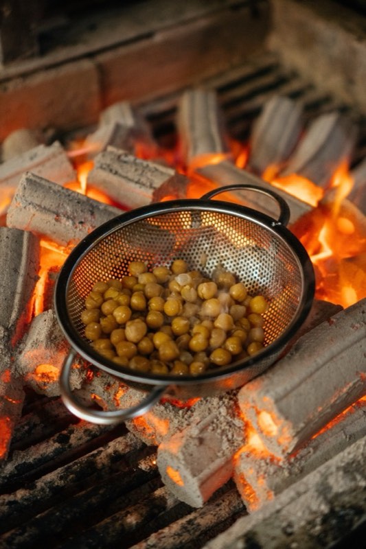 Chickpeas roasting over charcoal in Jannah's open-fire kitchen